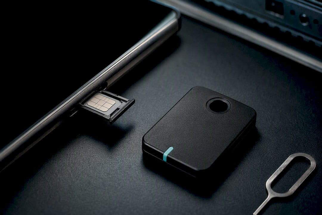 SIM tray and security key on graphite surface